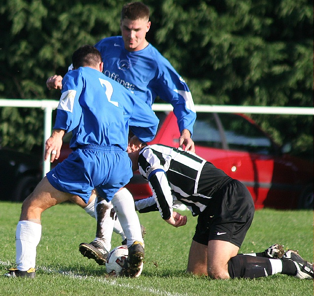 Phil Gault keeps his eye on the ball as Jon Simpson (2) intercepts
