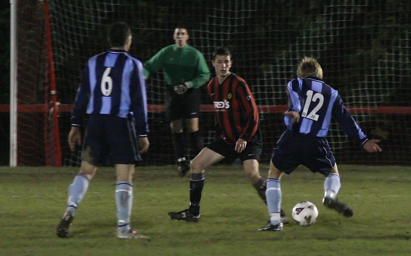 Jordan Wood (12) tries to place the ball past Dave Sharman
