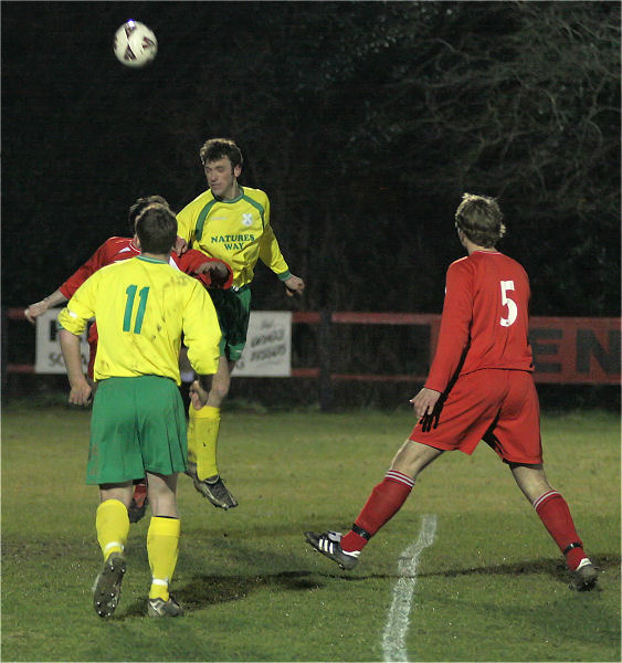 Jim Leggatt (?) heads towards goal
