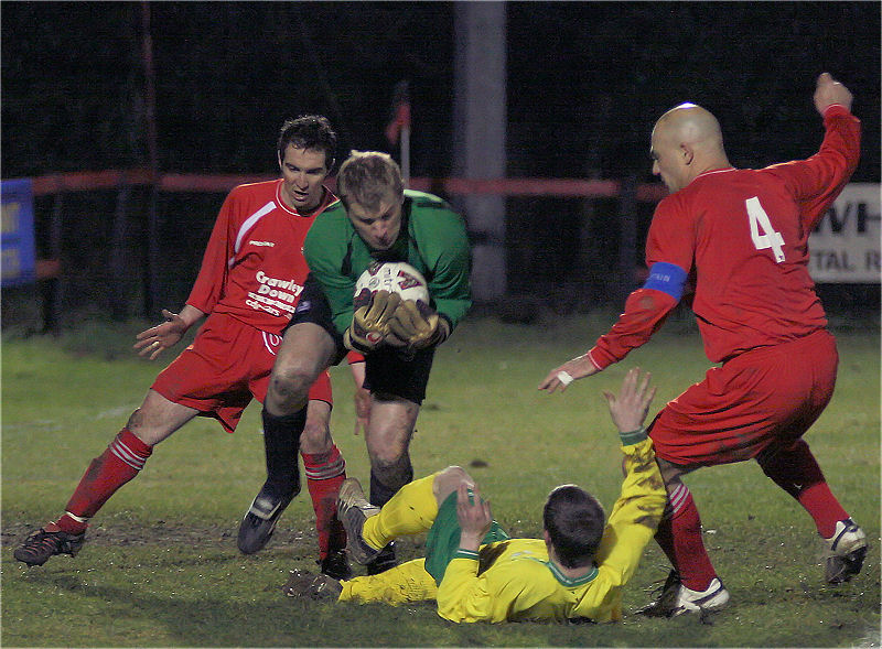Matt Heasman is challenged by Charlie Hammond (?) with Paul Otway close by
