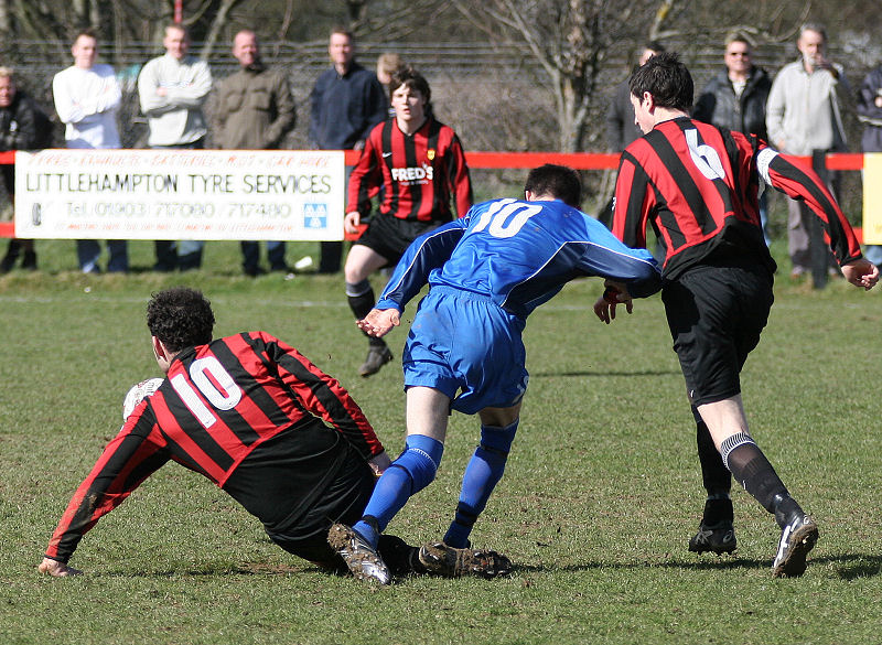 Pete Christodoulou clears the ball from Sonny Banks 
