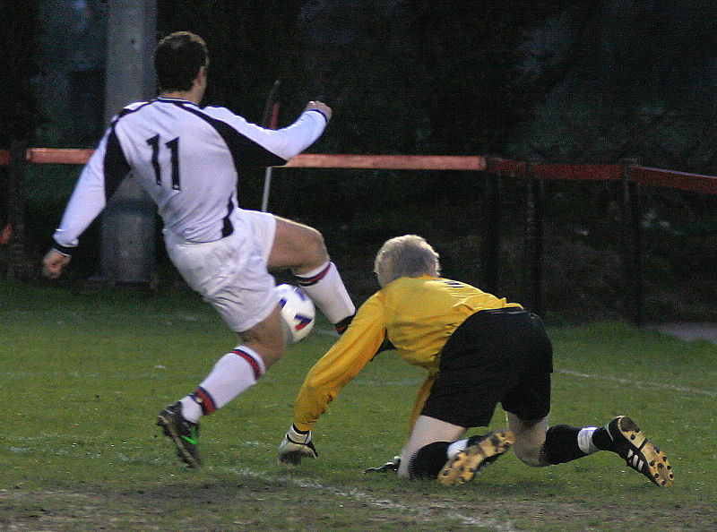 Tom Rand knocks the ball away from the feet of Stuart Sell
