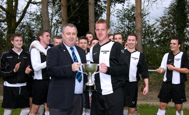 Loxwood captain Ollie Lambkin receives the SCFL Division 3 trophy from Steve Nealgrove
