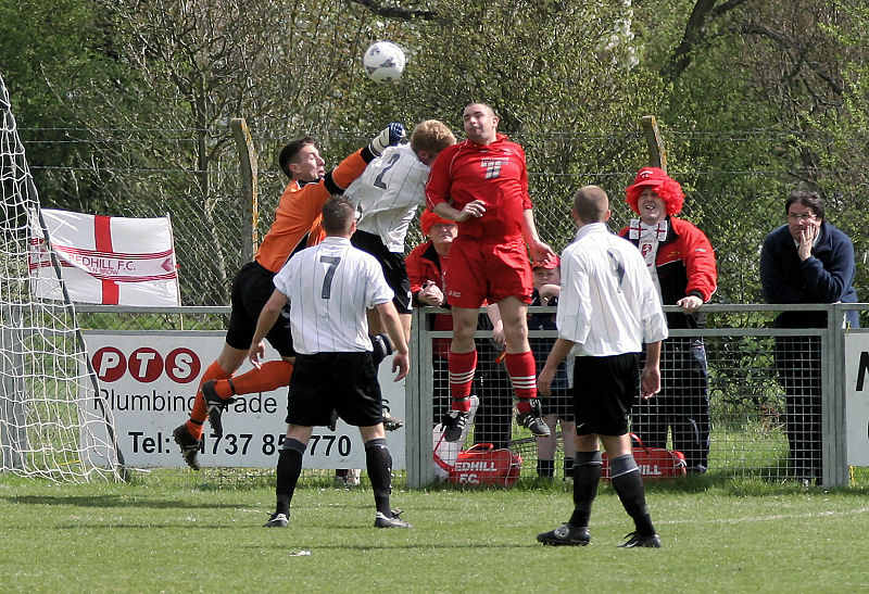 Simon Davey reaches over Dave Hall to punch away from Luke Jones
